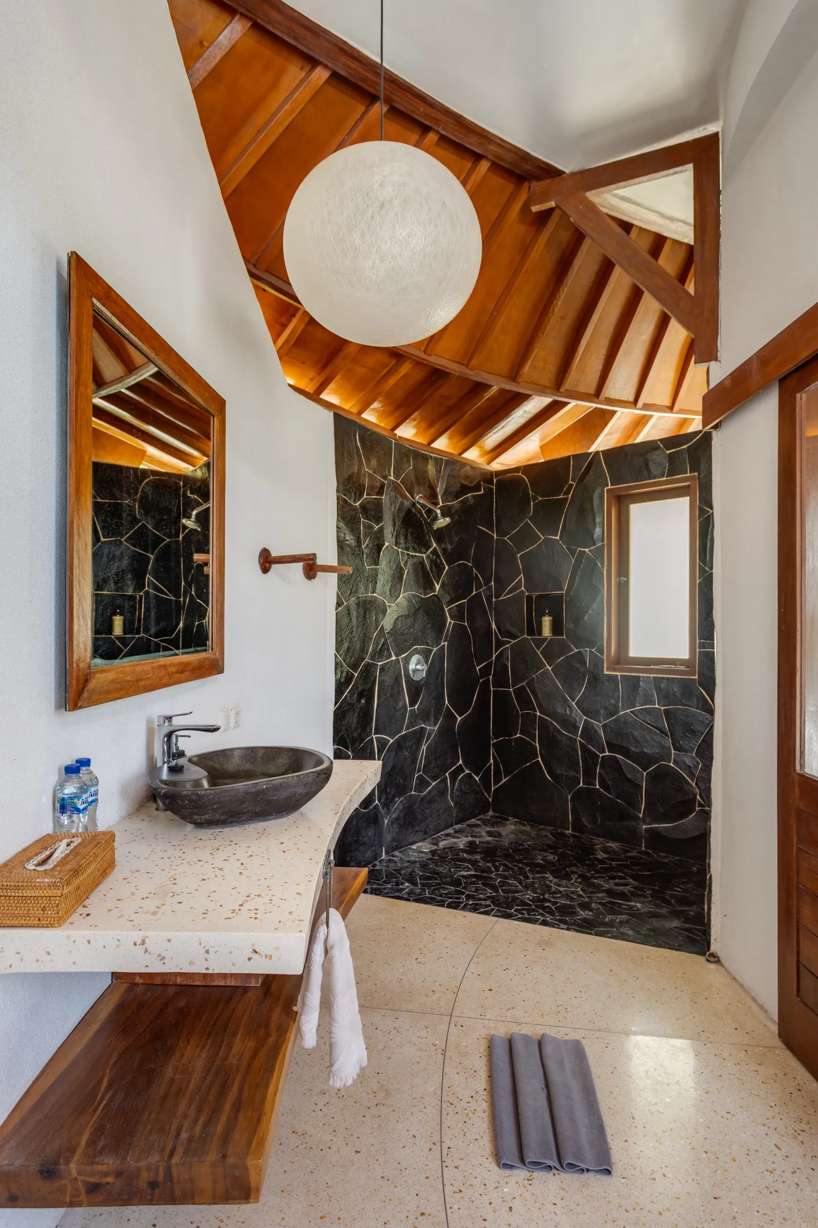 Stone-finished ensuite bathroom at Madu Bungalow Bingin