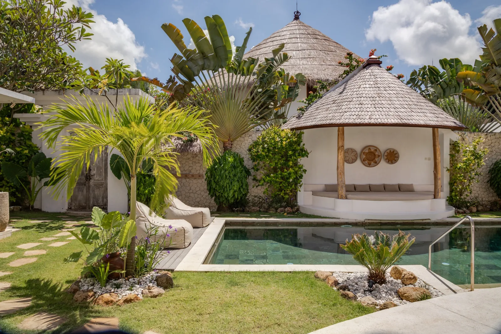 The thatched gazebo roof over the pool at Madu Bungalow Bingin, midday